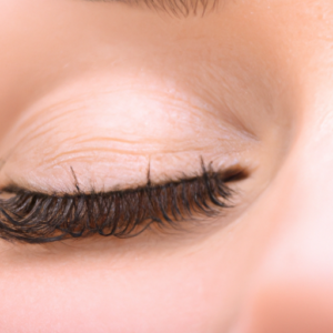 A close-up of eyelashes curling up.