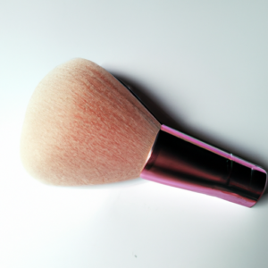 A light pink blush brush against a white background.