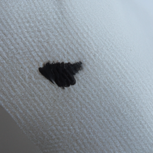A close-up of a tissue with black smudges.