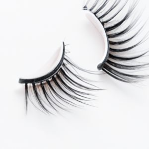 A close-up of a pair of false eyelashes on a white background.