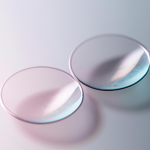 A close-up of a pair of contact lenses with a gentle pink tint.