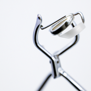 A close-up of an eyelash curler with its handle pointing towards the viewer.